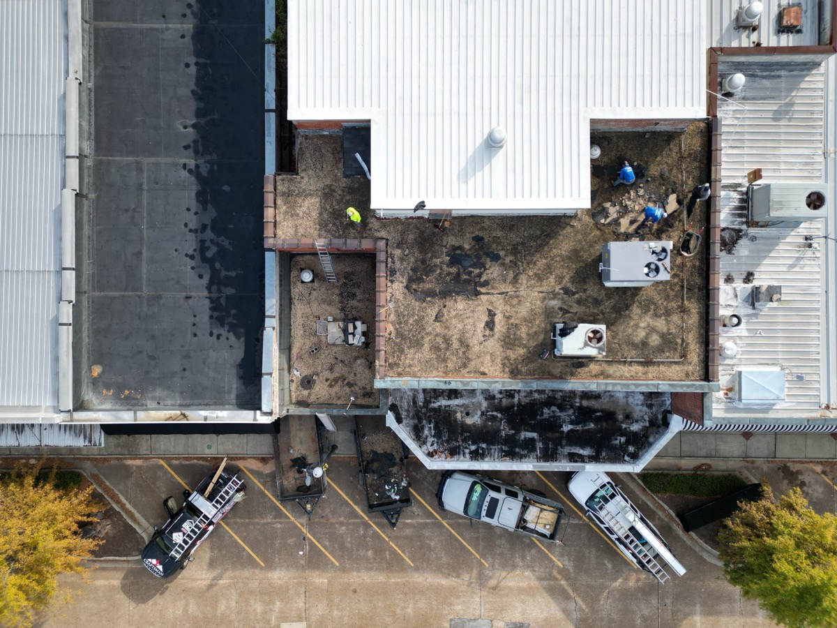 Before: deteriorating commercial flat roof in Tuscaloosa with ponding water and membrane failures