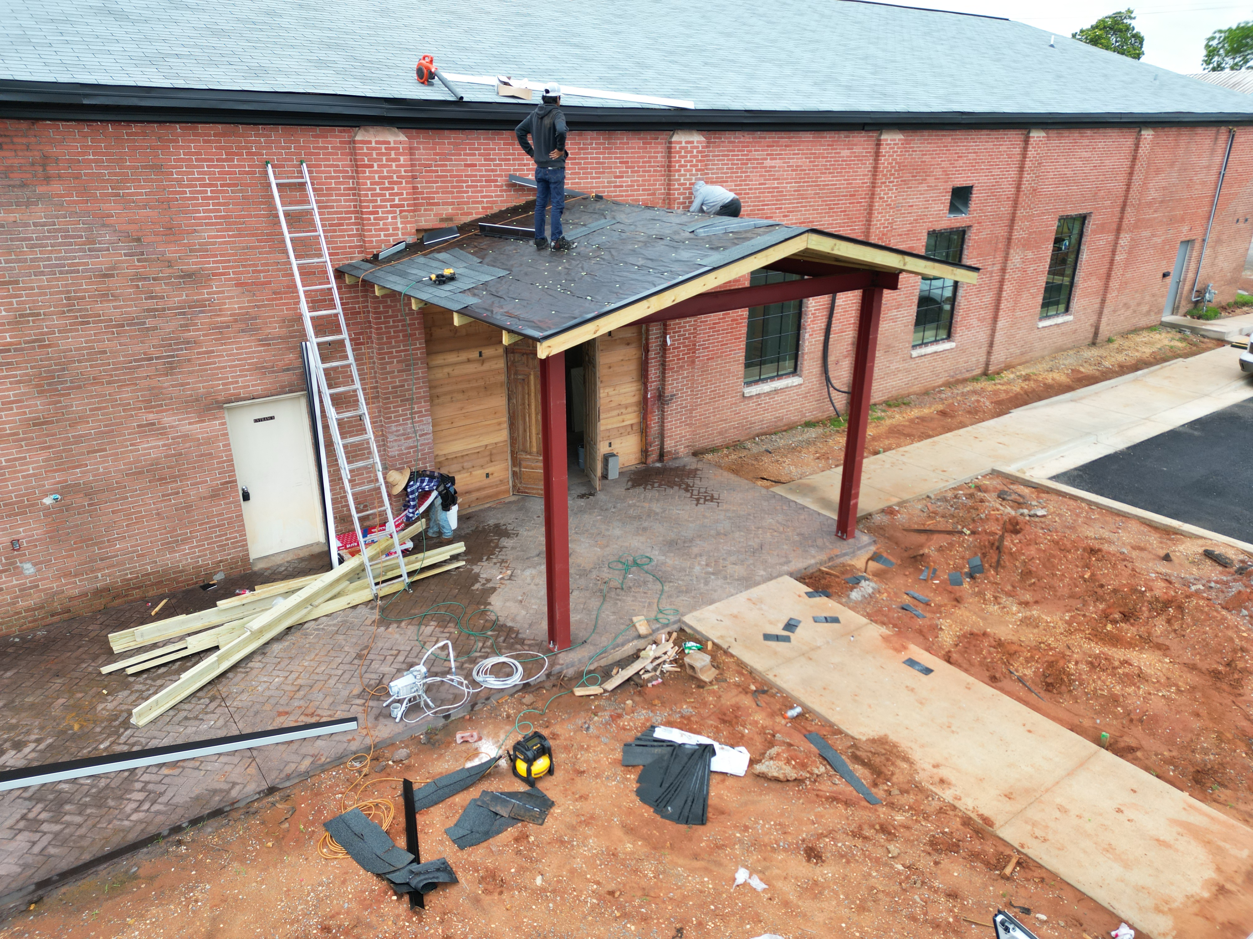 Wide view of Craftsman Roofing crew on a commercial roof job
