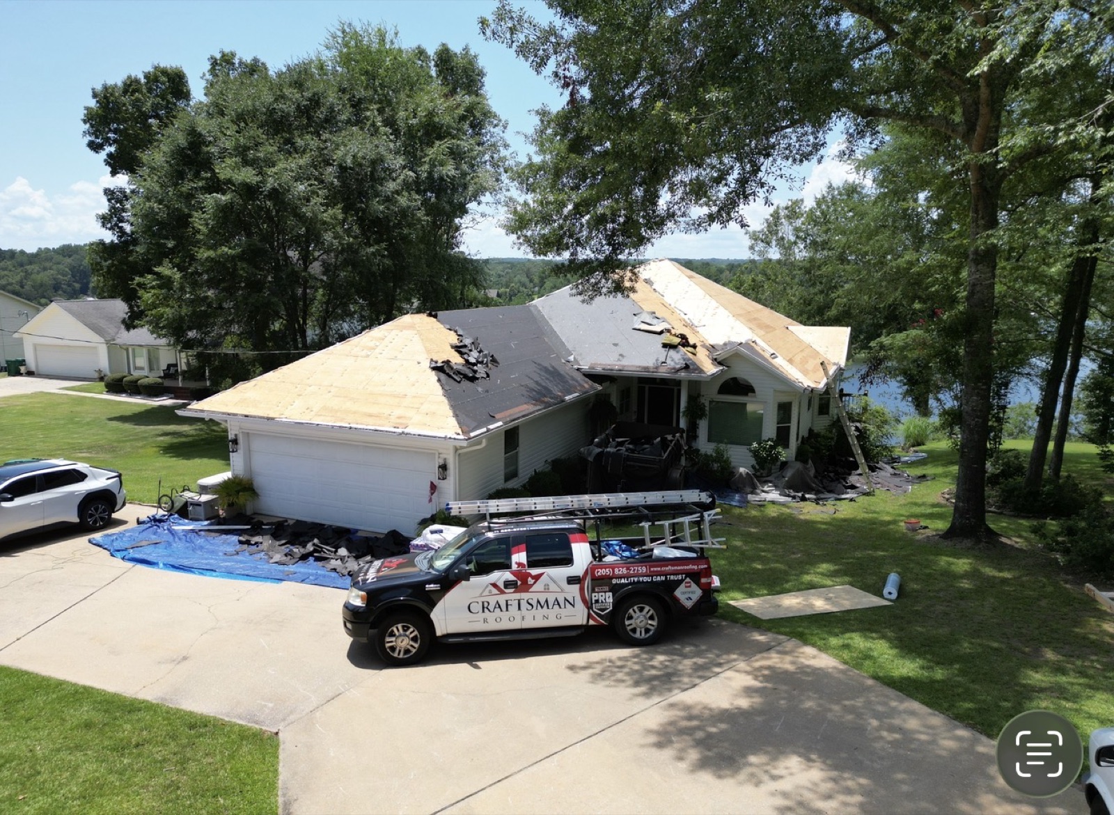 Craftsman Roofing truck in front of a completed residential roofing project